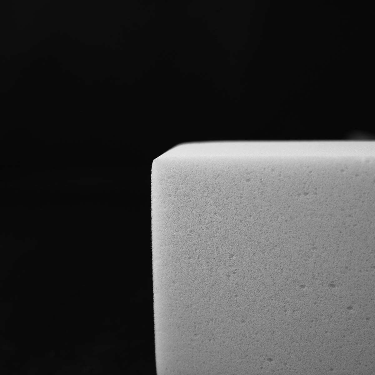 Close-up of a textured gray surface against a black background