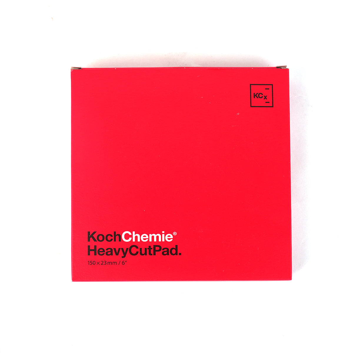 Red notebook with 'Koch Chemie HeavyCutPad' text on a white background