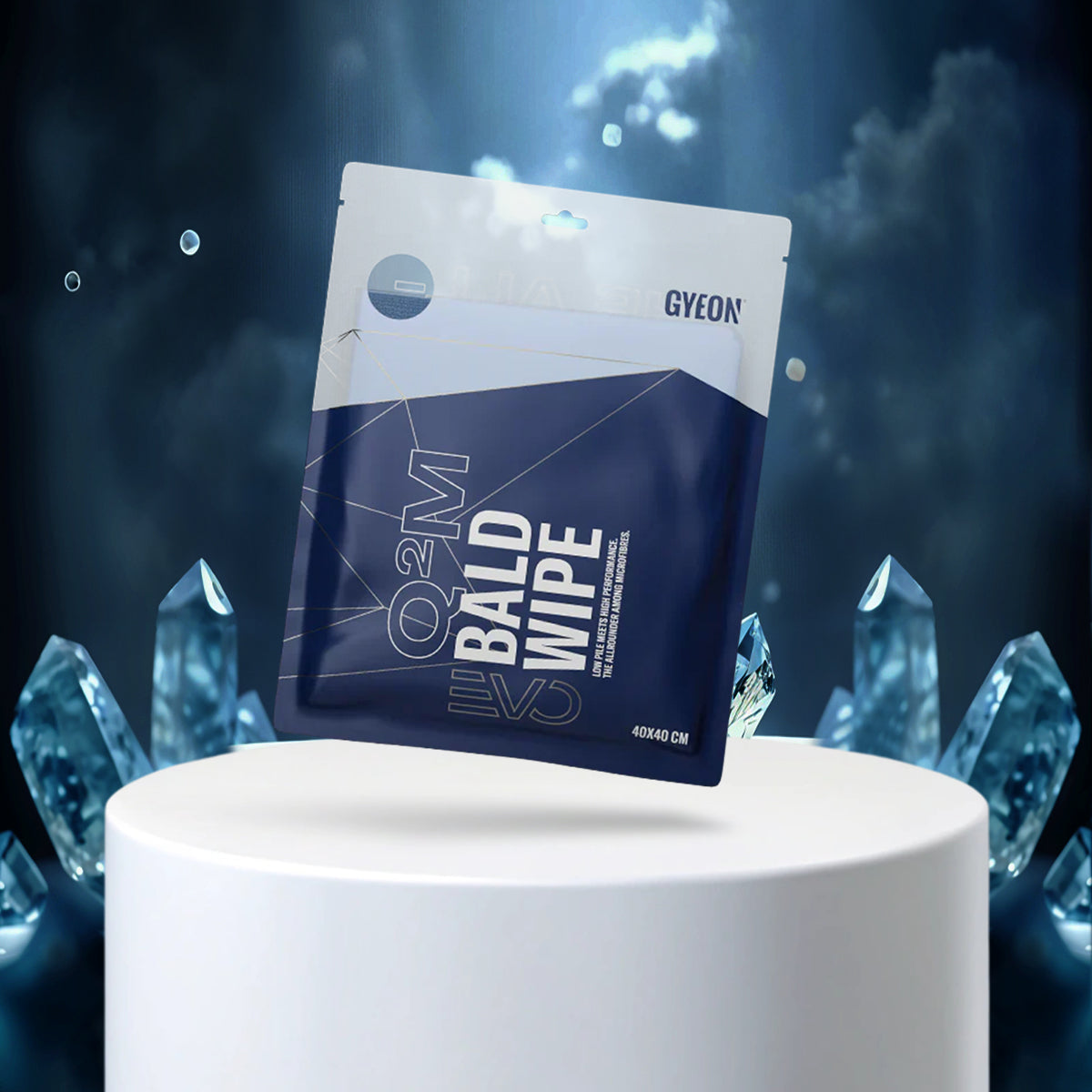 GYEON Q2M Bald Wipe packaging on a white pedestal with crystal-like structures against a dark blue background
