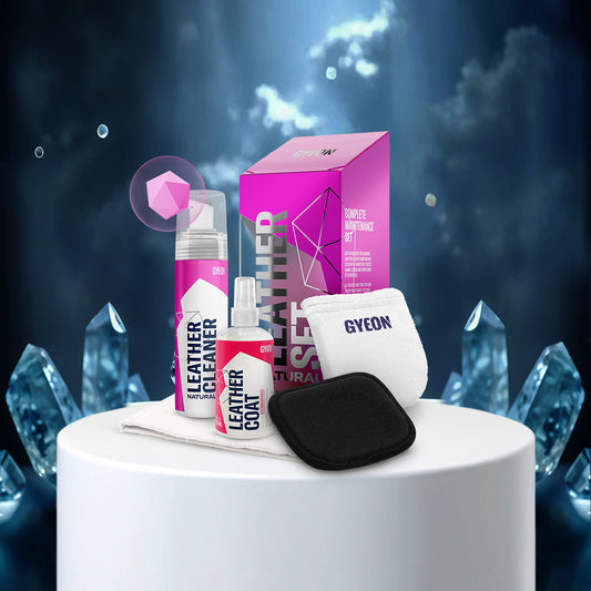 Gyeon leather care products on a white pedestal with a dark, crystal-like background