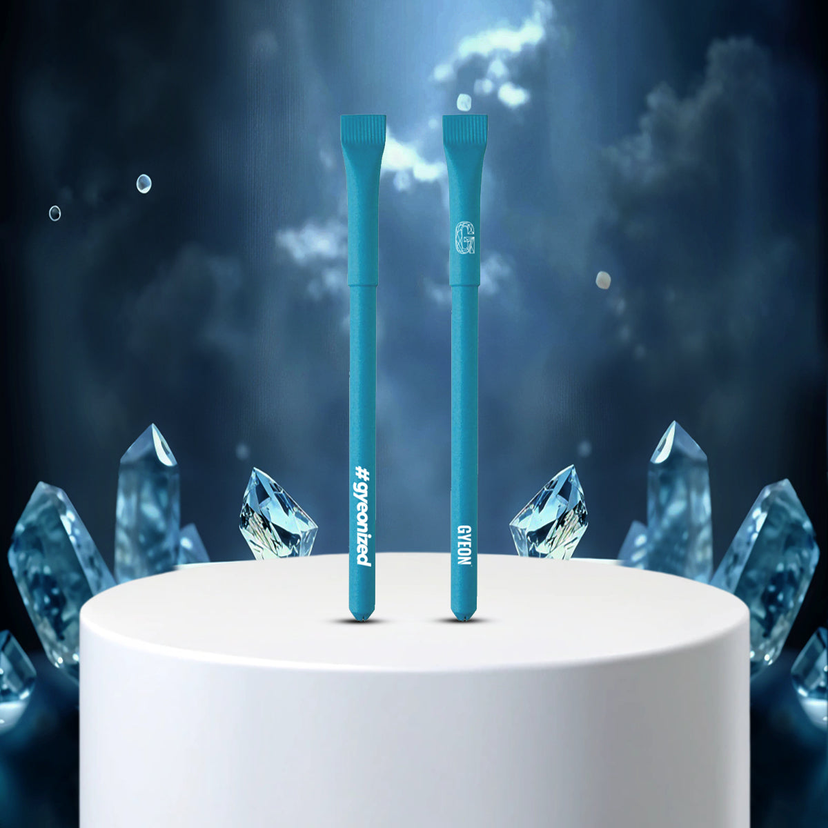 Two blue pens on a white pedestal with crystal-like structures against a dark, starry background.