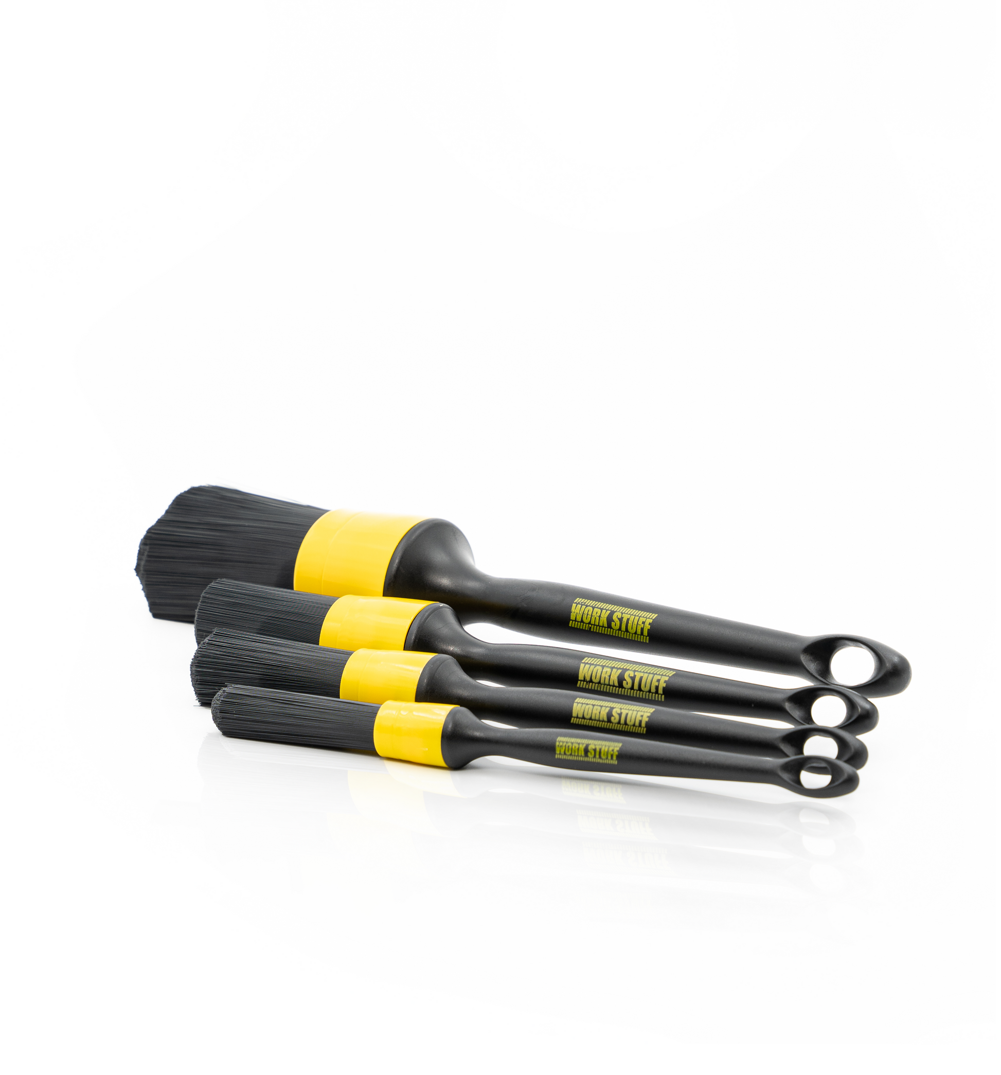 Set of four black and yellow brushes on a white background