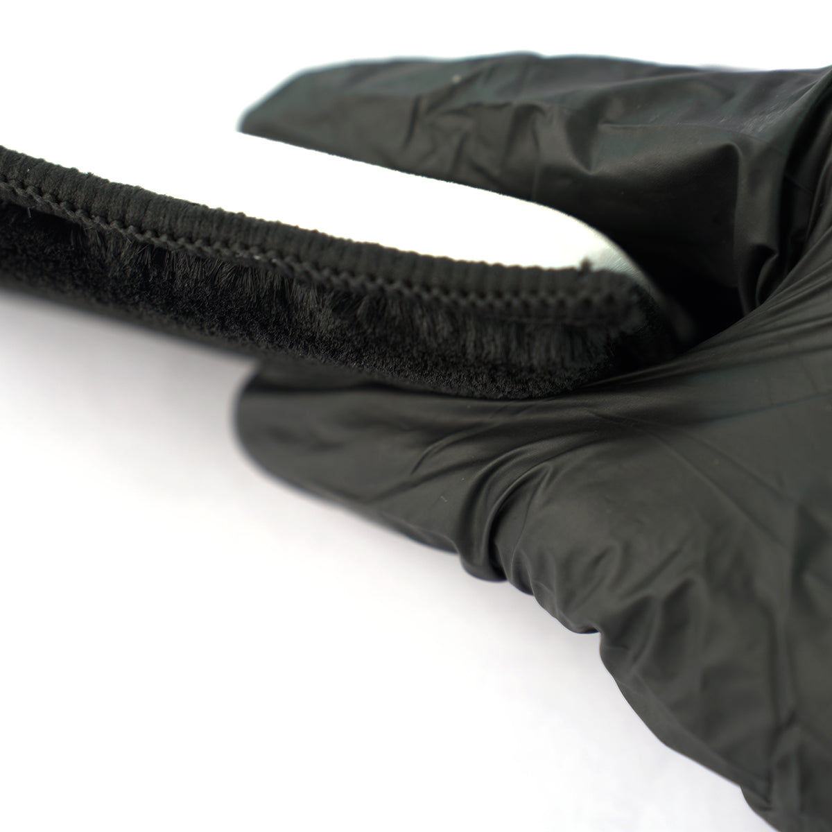 Close-up of a black quilted jacket with a hood on a white background