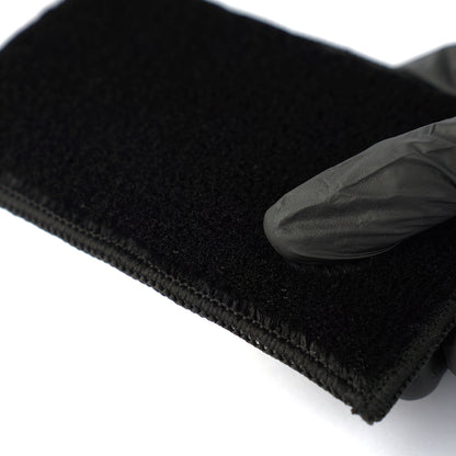 Black headband with a black glove on a white background