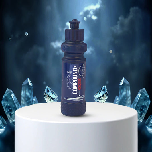 Blue bottle labeled 'Compound+' on a white pedestal with crystal-like structures in the background