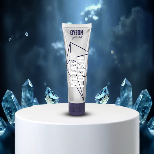 Gyeon product tube on a white pedestal with crystal-like shapes in the background