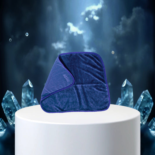 Blue pillow on a white pedestal with crystal-like structures in the background