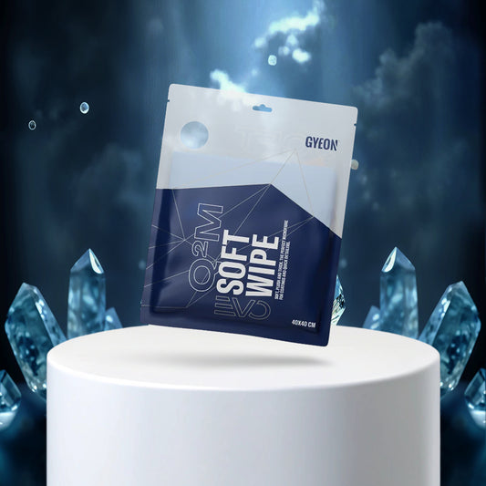 Gyeon soft wipe packaging on a white pedestal with blue crystal-like structures in the background