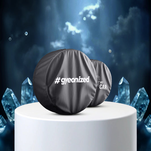 Car wheel cover with '#gyeonized' branding on a white pedestal against a mystical blue crystal background.