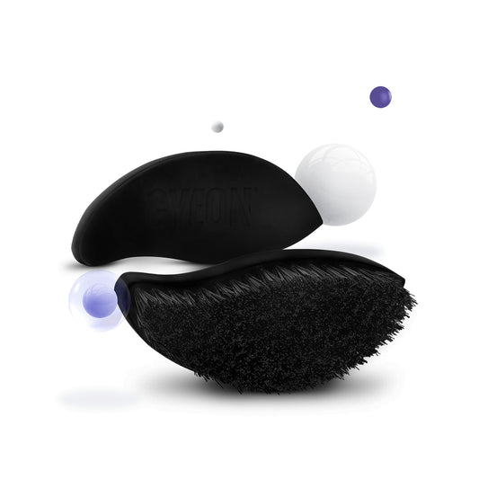 Black grooming brush with bristles on a white background