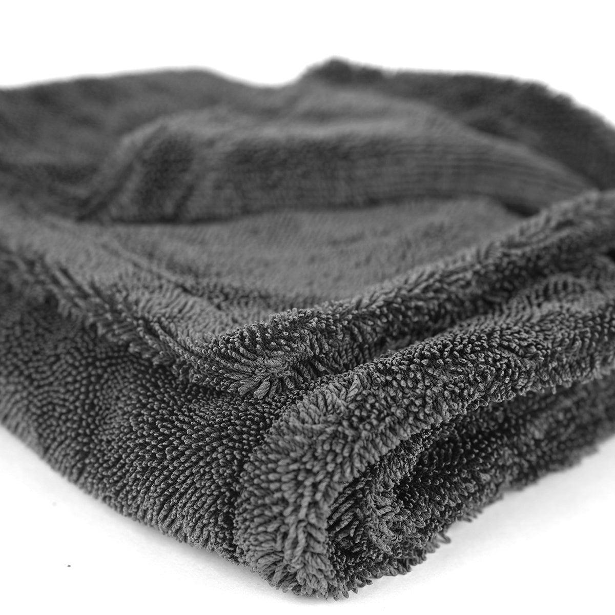 Folded dark gray towel on a white background