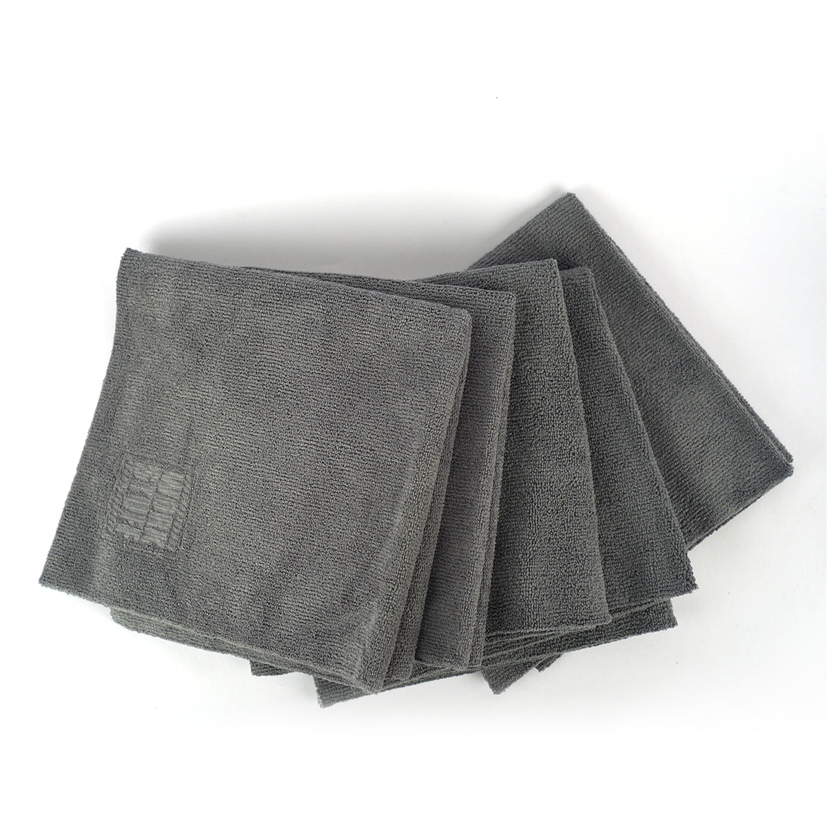 Stack of gray microfiber cloths on a white background