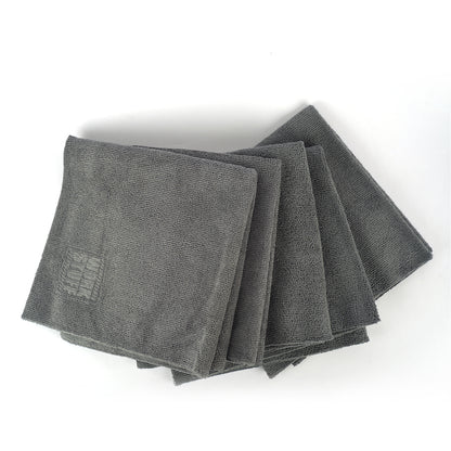 Stack of gray microfiber cloths on a white background