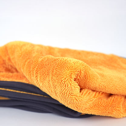 Stack of orange and black microfiber cloths on a white background